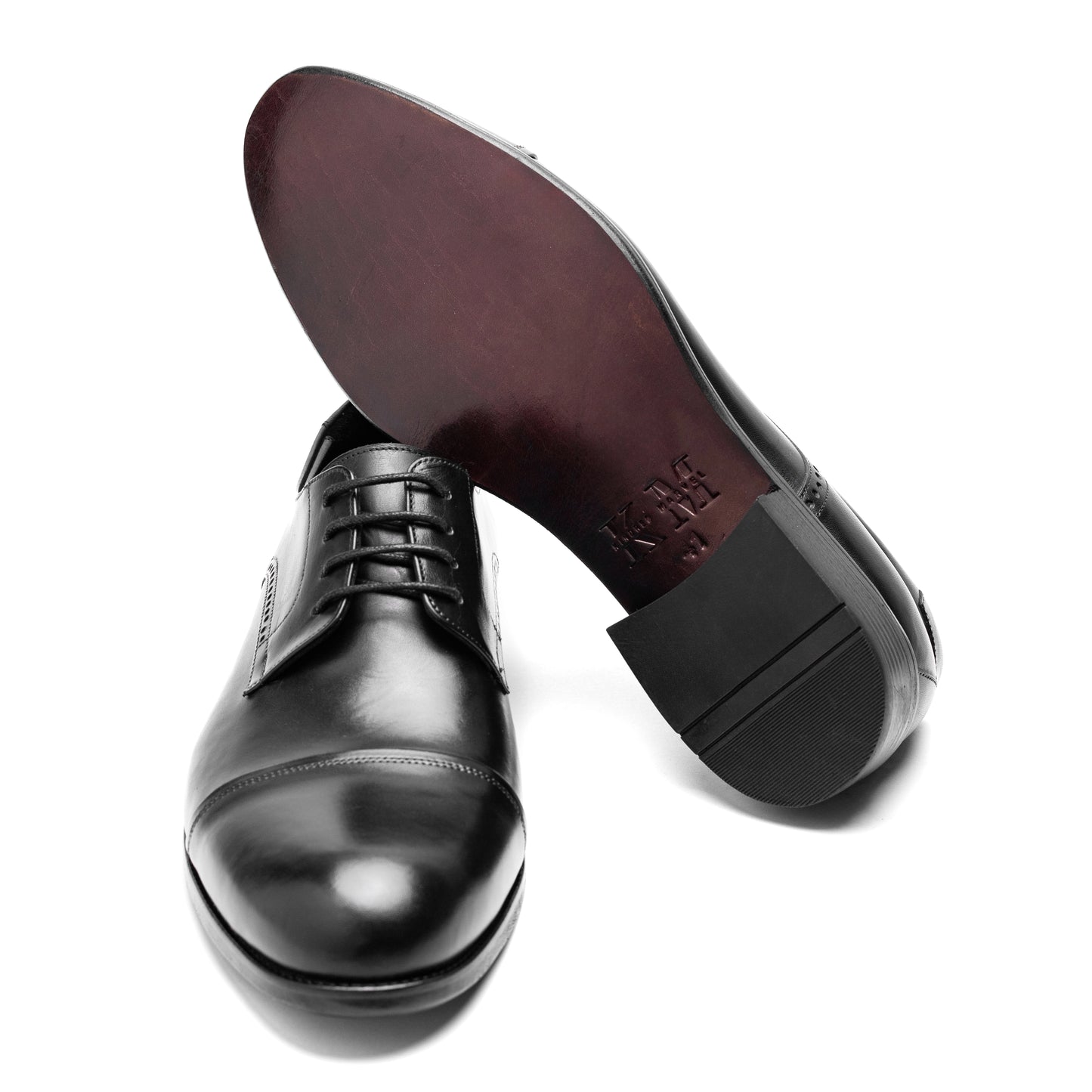 Bottom view of the Cap Toe Derby Black shoe, featuring a rubber sole for slip resistance and all-day comfort