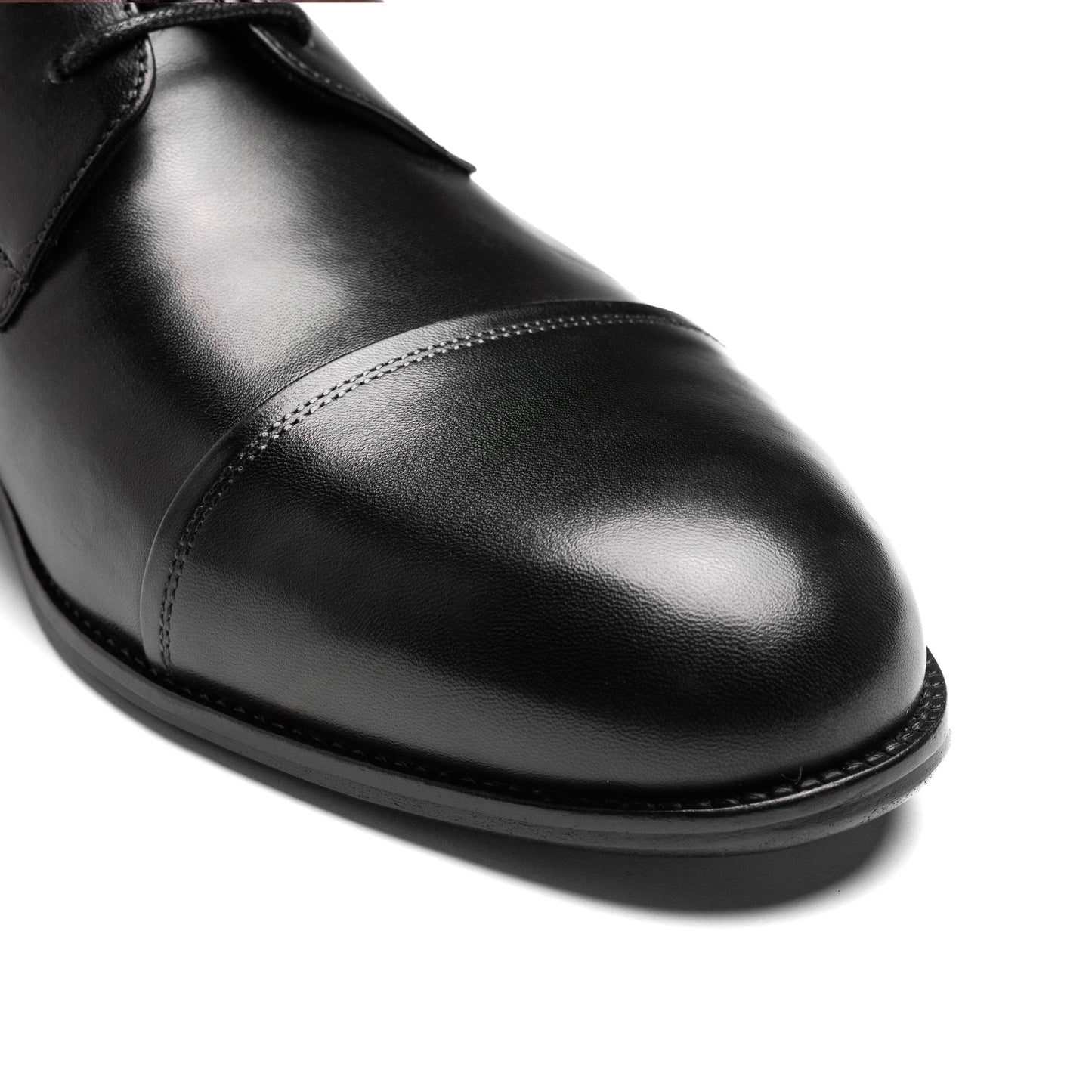 Cap Toe Derby Black captured at a three-quarter angle, highlighting its elegant silhouette and artisanal finish